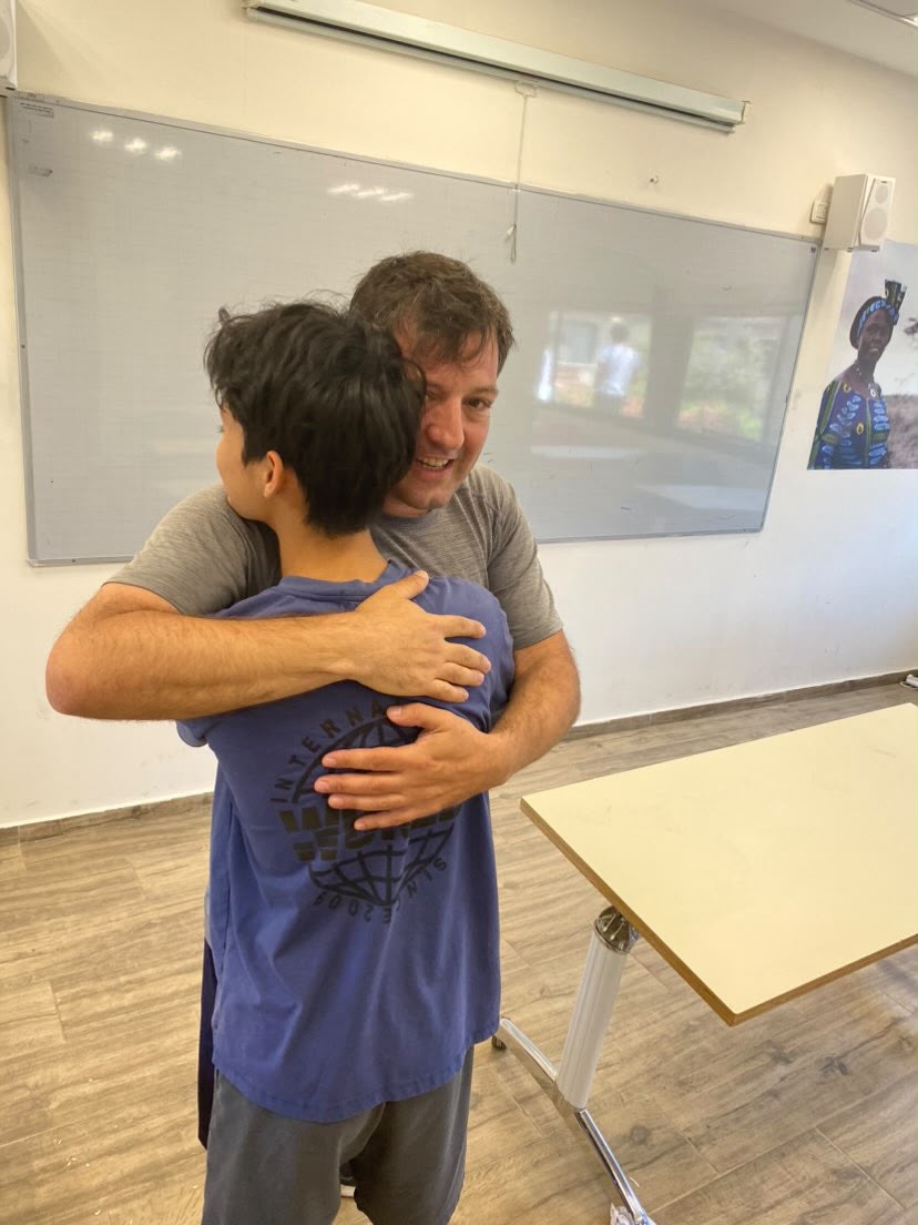 A moment between teacher and student, in the classroom.